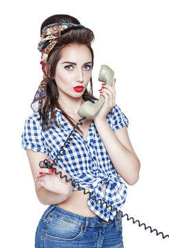 Young beautiful woman in pin-up style with retro telephone isola