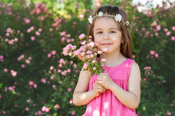 Portrait of beautiful little girl with roses flowers © Tomsickova