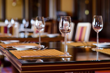 Wine glasses on served table/Empty wine glasses on a wooden served table  in the restaurant