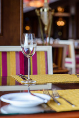 Wine glass on a table in a restaurant/An empty wine glass on a table in the lobby of the restaurant