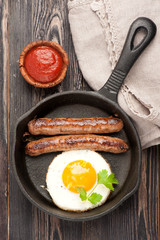 Grilled homemade sausages with fried egg. Top view, vertical