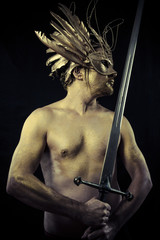 Soldier, Warrior with helmet and sword with his body painted gol © Outsiderzone