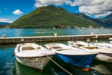 Fototapeta na wymiar Harbour and boats at Boka Kotor bay (Boka Kotorska), Montenegro, Europe.