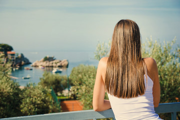 Fototapeta na wymiar Beautiful young woman looking at the sea. Montenegro, Europe. Toning image.