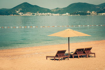 Beautiful beach with sunshades in Montenegro, Balkans, Adriatic Sea.