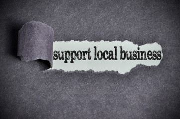 support local business word under torn black sugar paper