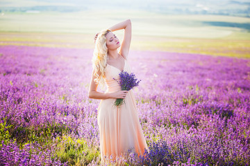 Fototapeta na wymiar Portrait of a beautiful girl on the lavender field.