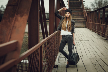 Outdoor fashion lifestyle portrait of pretty young girl, wearing in hipster swag grunge style urban...