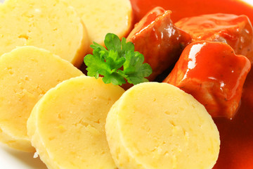 Pork in tomato sauce with potato dumplings