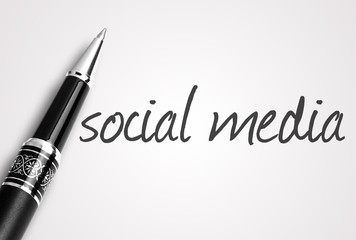 Fototapeta premium pen writes social media on paper
