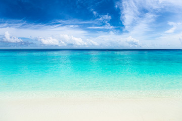 tropical paradise beach with crystal clear, turquoise blue water, wonderful clouds and sky
