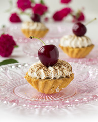 Cupcake with cherries, whipped cream and flowers