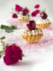 Cupcake with cherries, whipped cream and flowers