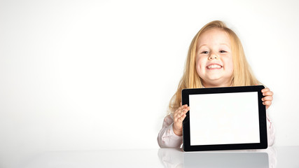 Cute little and smiling girl plays with a tablet © Jarek Pawlak