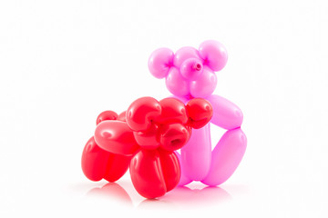 Balloon animal of red pig and pink bear.