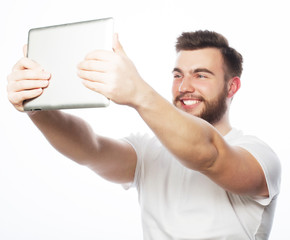 young bearded man holding tablet