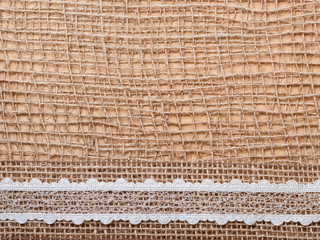 Lace ribbon on burlap cloth background