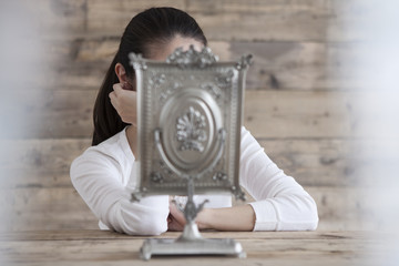 Women are feeling lonely in front of the mirror
