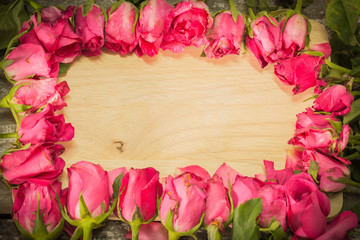 Naklejka na ściany i meble Roses on a wooden background