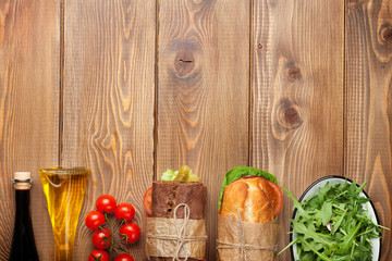 Two sandwiches, salad and spices