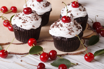 Beautiful chocolate cupcakes with white cream and cherry, horizontal
