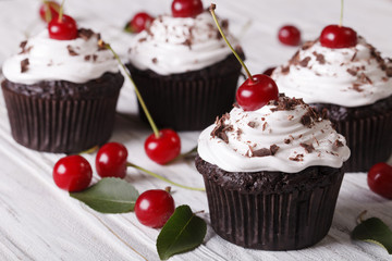Chocolate cupcakes with cream and fresh cherry horizontal

