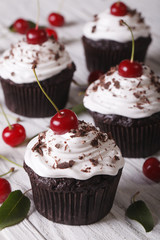 Chocolate cupcakes with white cream and cherry, vertical
