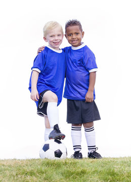 Two diverse young soccer players on white background. Full length view of two youth recreation league soccer players.
