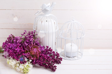 Lilac  and candles on wooden background.