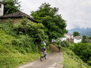 Mountain bikers in an old mountain village. Bulgaria.