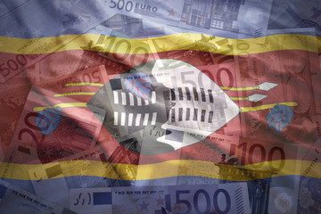 colorful waving swaziland flag on a euro money background