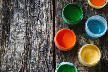 colorful gouache paint on an old wooden table