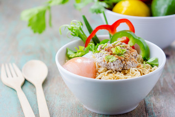 Chinese noodles with minced pork and egg in bowl