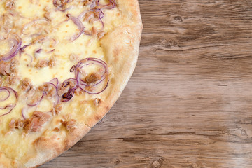 pizza onion and tuna on wooden table
