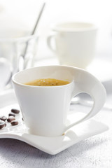 Cup of coffee on white wooden background