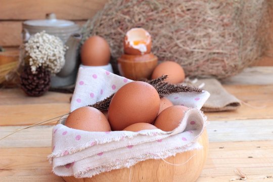 soft-boiled egg and eggs on wood background