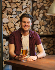 Fototapeta na wymiar happy man drinking beer at bar or pub