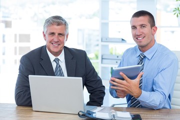 Businessmen working together with laptop and tablet