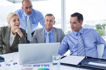 Business team working together on laptop