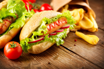 Grilled hot dogs with mustard and ketchup on a picnic wooden table
