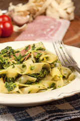 Spaghetti with spinach and bacon.