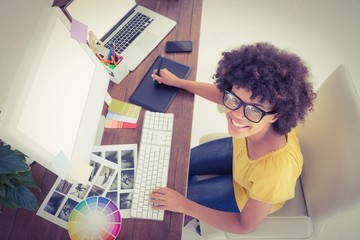 Fototapeta na wymiar Creative businesswoman typing on laptop