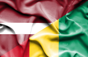 Waving flag of Guinea and Latvia