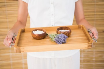 Therapist holding tray of beauty treatments