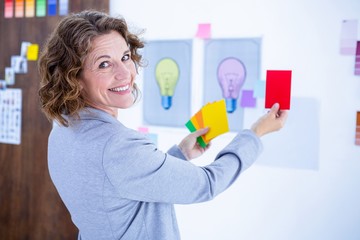 Creative businesswoman holding color cards