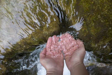 Woman's hands with water splash