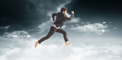 Fototapeta na wymiar Composite image of businessman leaping