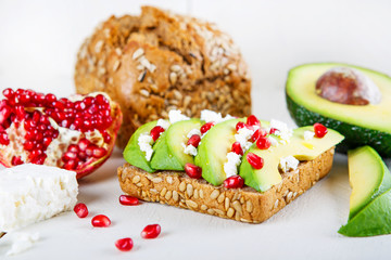 Avocado with Feta, pomegranate on sunflower seeds bread sandwich