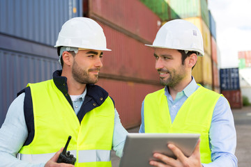 Fototapeta premium Two young attractives dockers working on the dock