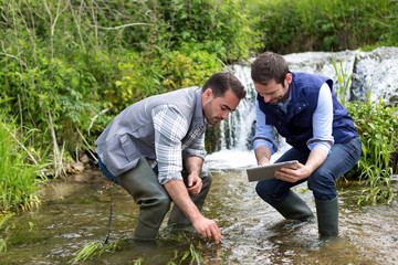 Scientist and biologist working together on water analysis